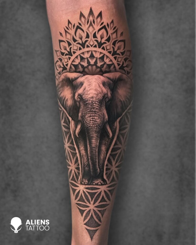 Geometric elephant sleeve tattoo with sacred patterns