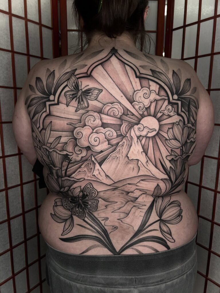 Bold Skull And Rose Blast Over Back Tattoo