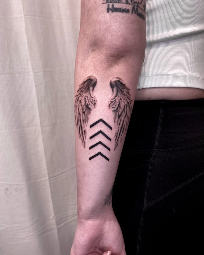 Shaded Angel Wings with Chevron Arrows Forearm Tattoo angel wings tattoo ideas tattoo