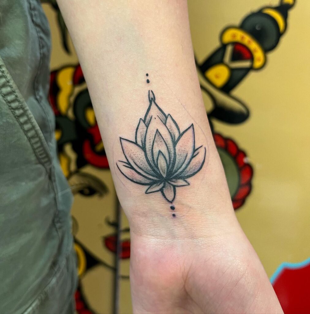 Shaded Lotus Wrist Tattoo with Dot Accents flower wrist tattoo ideas tattoo