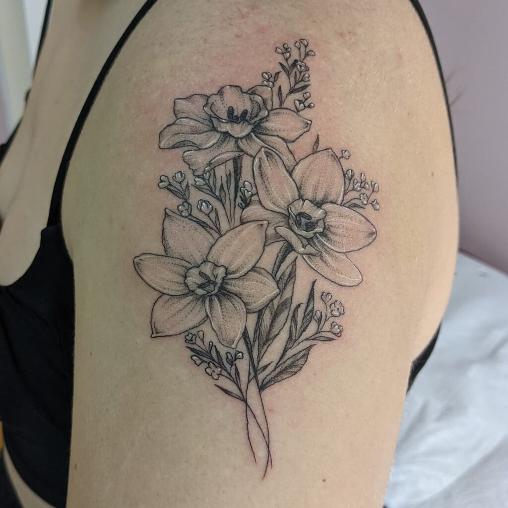 Shaded Narcissus Shoulder Tattoo with Baby’s Breath december birth flower tattoo ideas tattoo