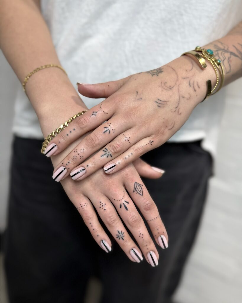 Minimalist small finger tattoo on the side of the knuckle