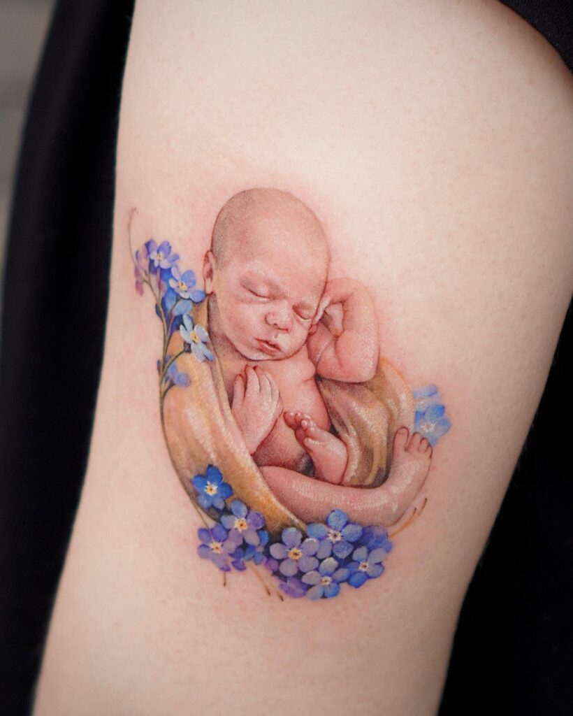 Sleeping Baby with Forget-Me-Nots Tattoo mom with kids tattoos tattoo