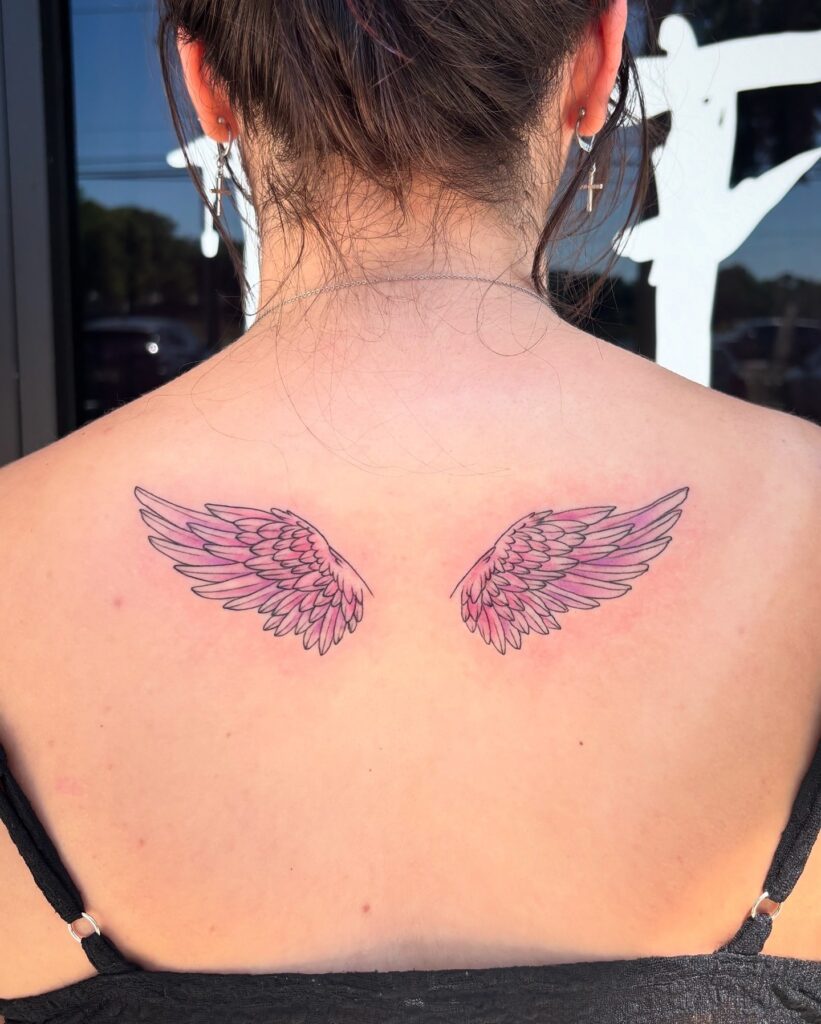 Small Pink Angel Wings Tattoo on Upper Back angel wings tattoo ideas on back tattoo