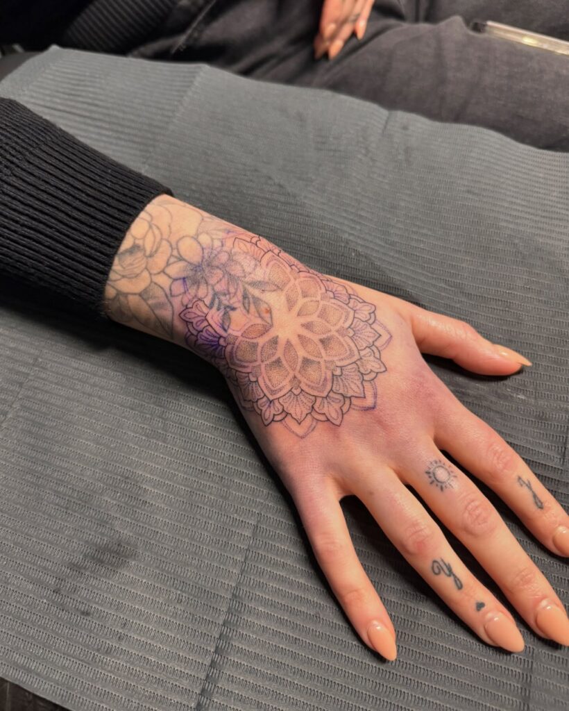 Soft Mandala Hand Tattoo with Fine-Line Detail mandala wrist tattoo ideas tattoo