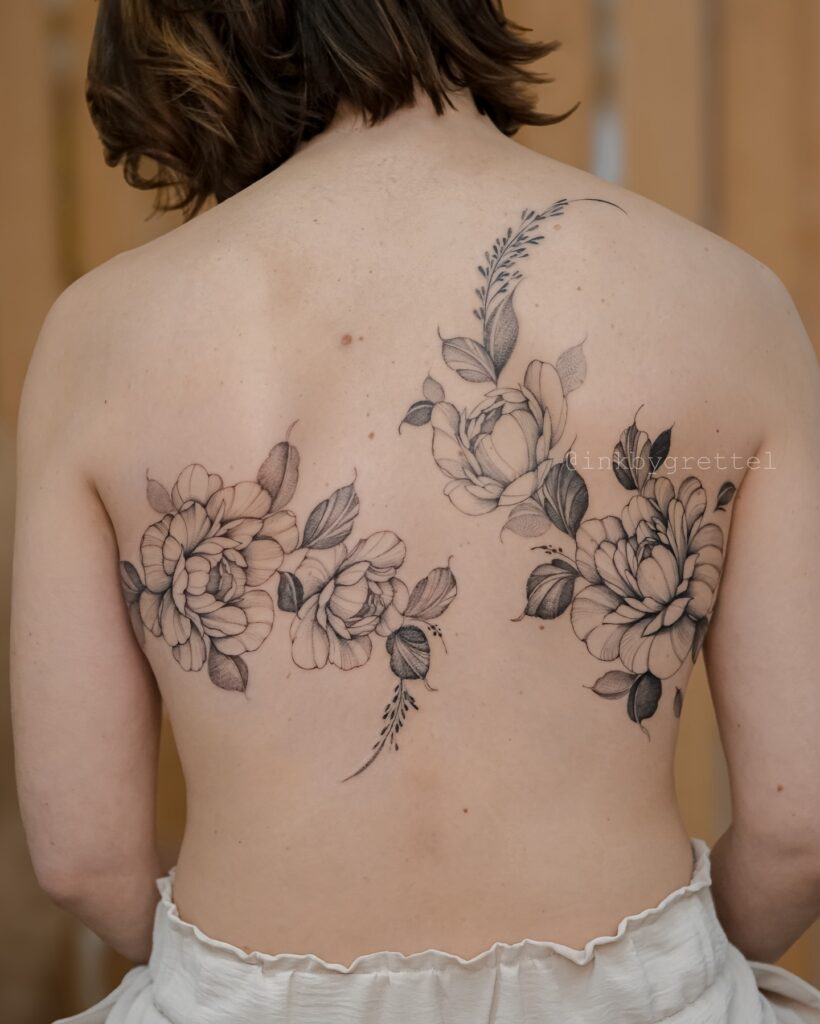 Bold Blackwork Back Tattoo With Florals And Geometric Frame