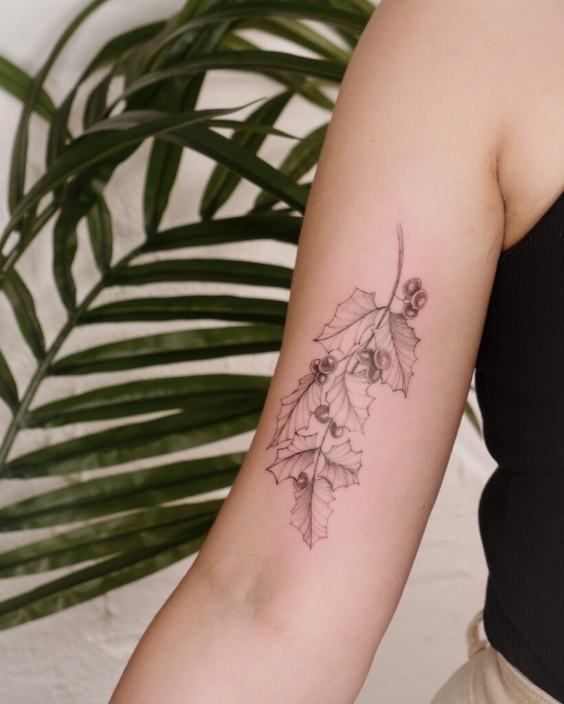 Soft Shaded Holly Sprig Tattoo on Upper Arm december birth flower tattoo ideas tattoo
