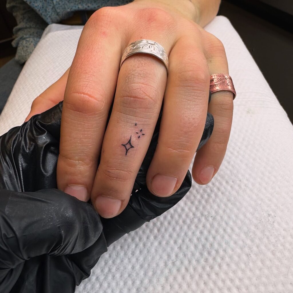 Minimalist Crescent Moon Finger Tattoo
