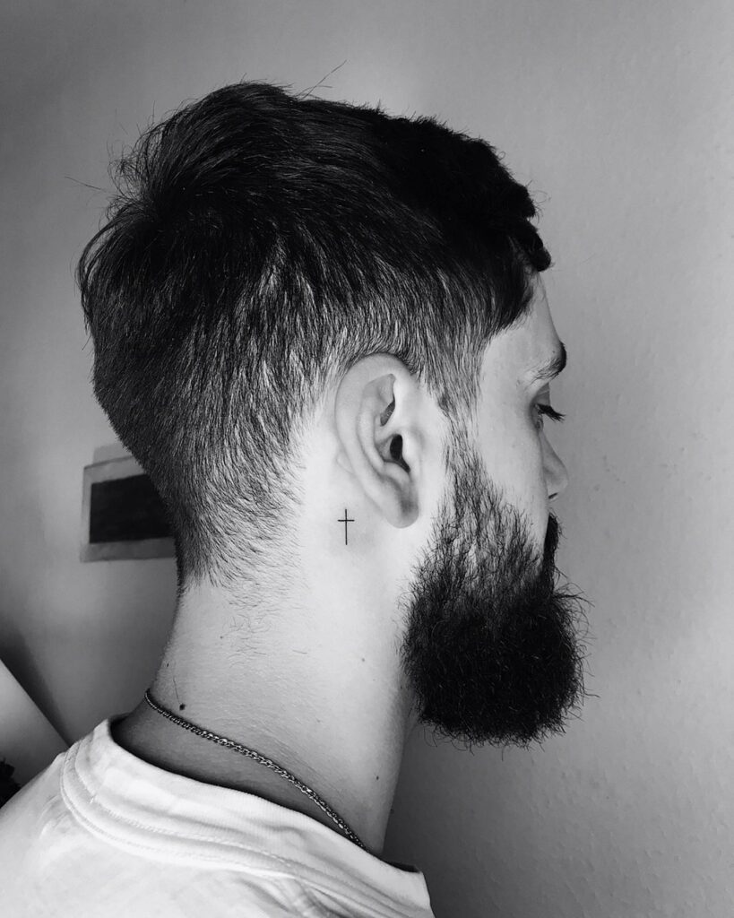 Subtle fine cross behind the ear