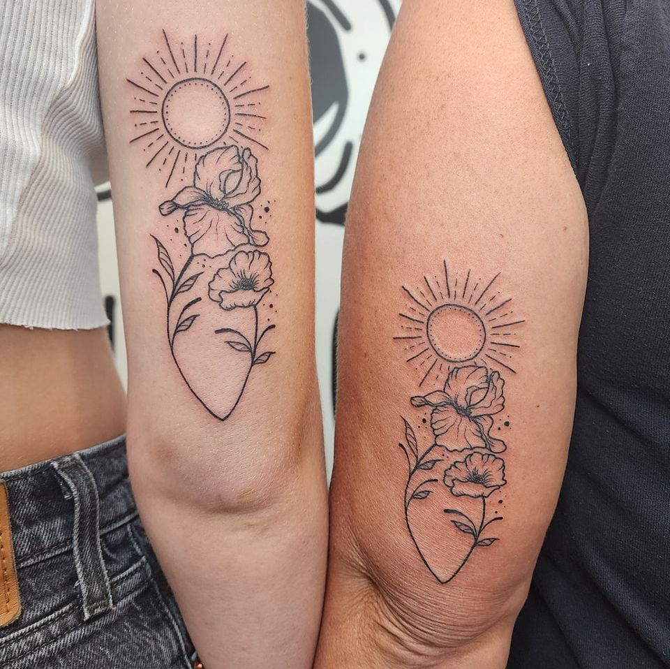 Sun and Floral Harmony Mother-Daughter Tattoo mother and daughter tattoo ideas tattoo