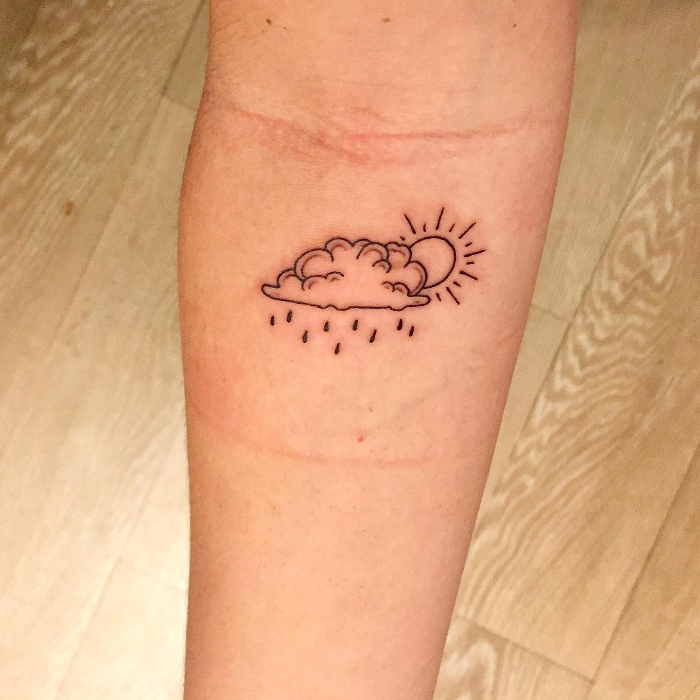 Sun Cloud and Rain Forearm Tattoo