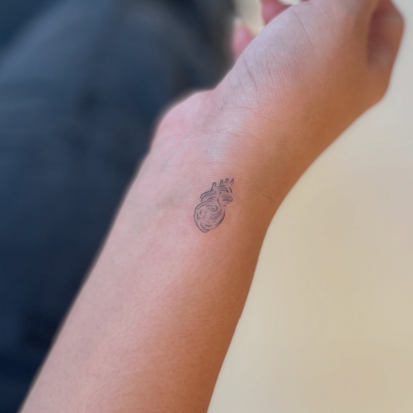 Tiny Anatomical Heart Wrist Tattoo