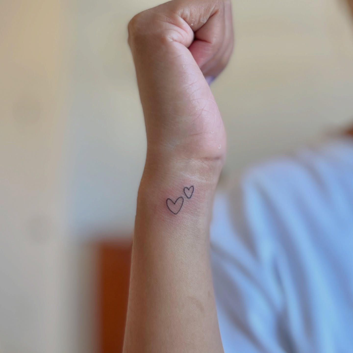 Tiny Linework Butterfly Wrist Tattoo