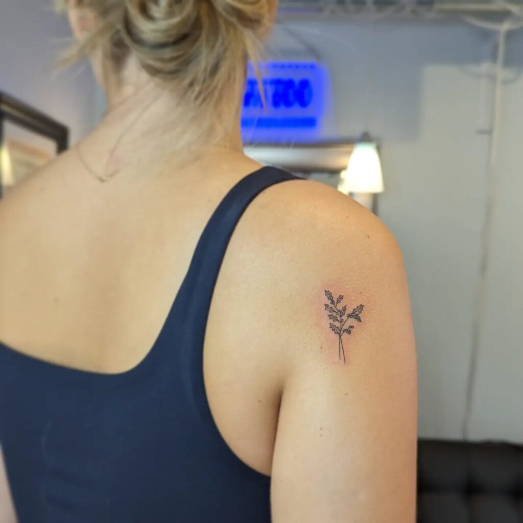Tiny Holly Sprig Tattoo on Shoulder december birth flower tattoo ideas tattoo