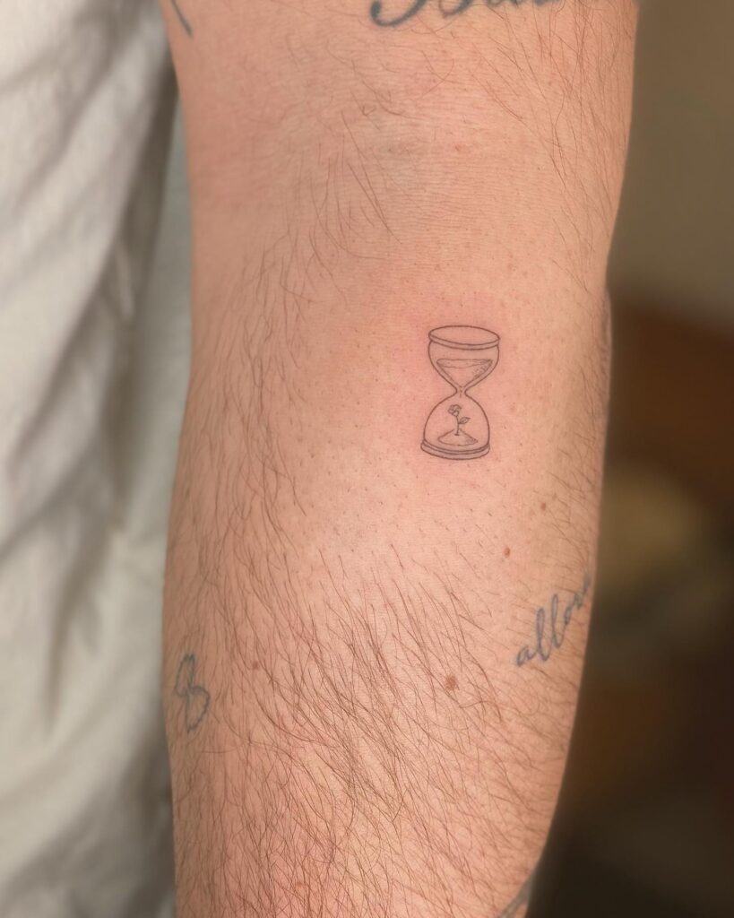 Tiny Hourglass with a Blooming Flower Tattoo hourglass tattoo ideas tattoo