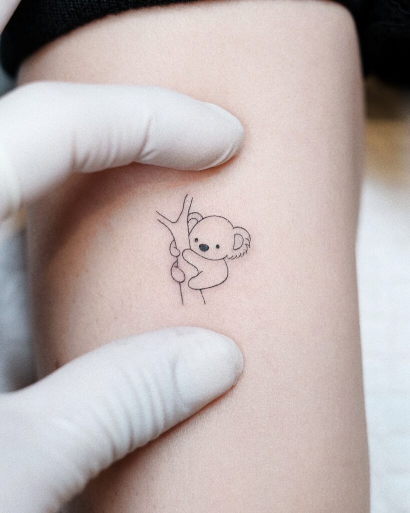 Tiny Koala Hug Tattoo meaningful tiny tattoos tattoo