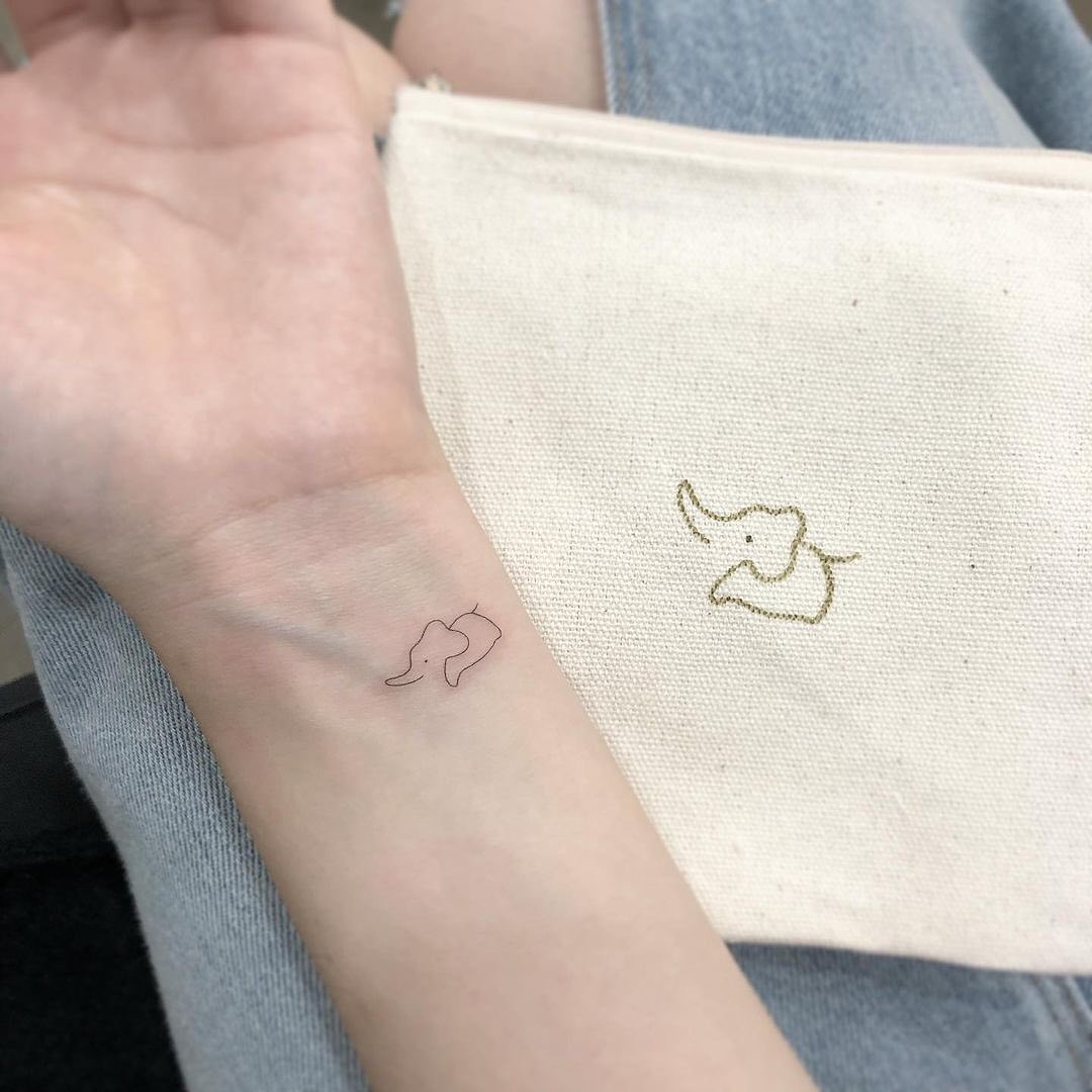 Tiny Flying Dove Wrist Tattoo