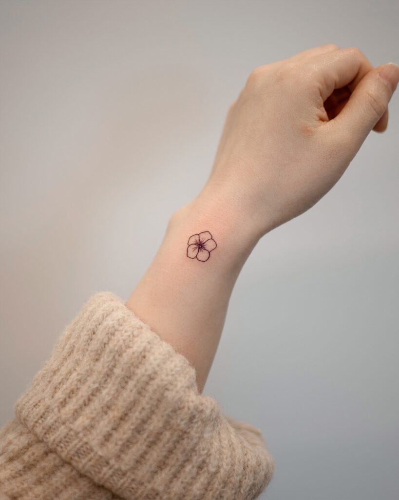 Tiny Linework Flower Wrist Tattoo meaningful tiny tattoos tattoo