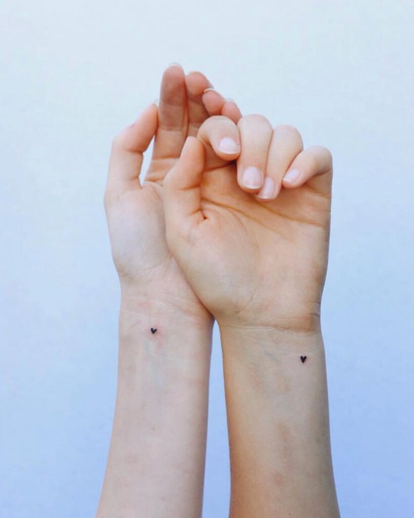Tiny Outline Hearts matching sibling tattoo