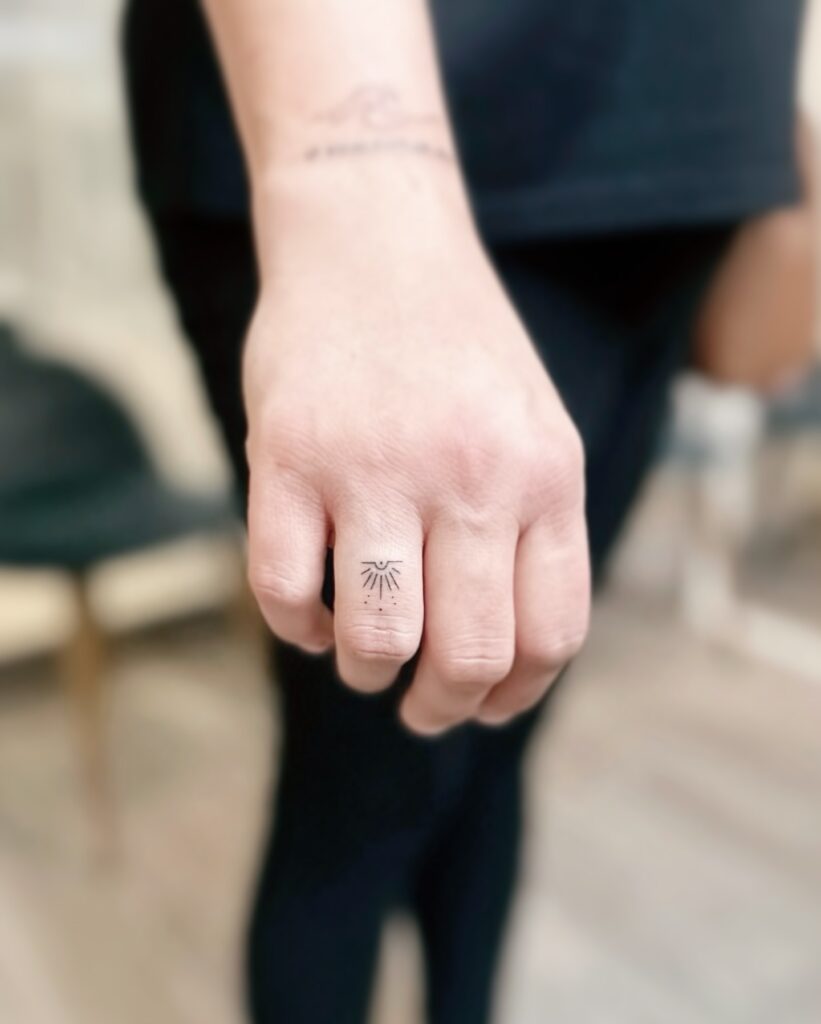Heart With Tiny Flower Finger Tattoo