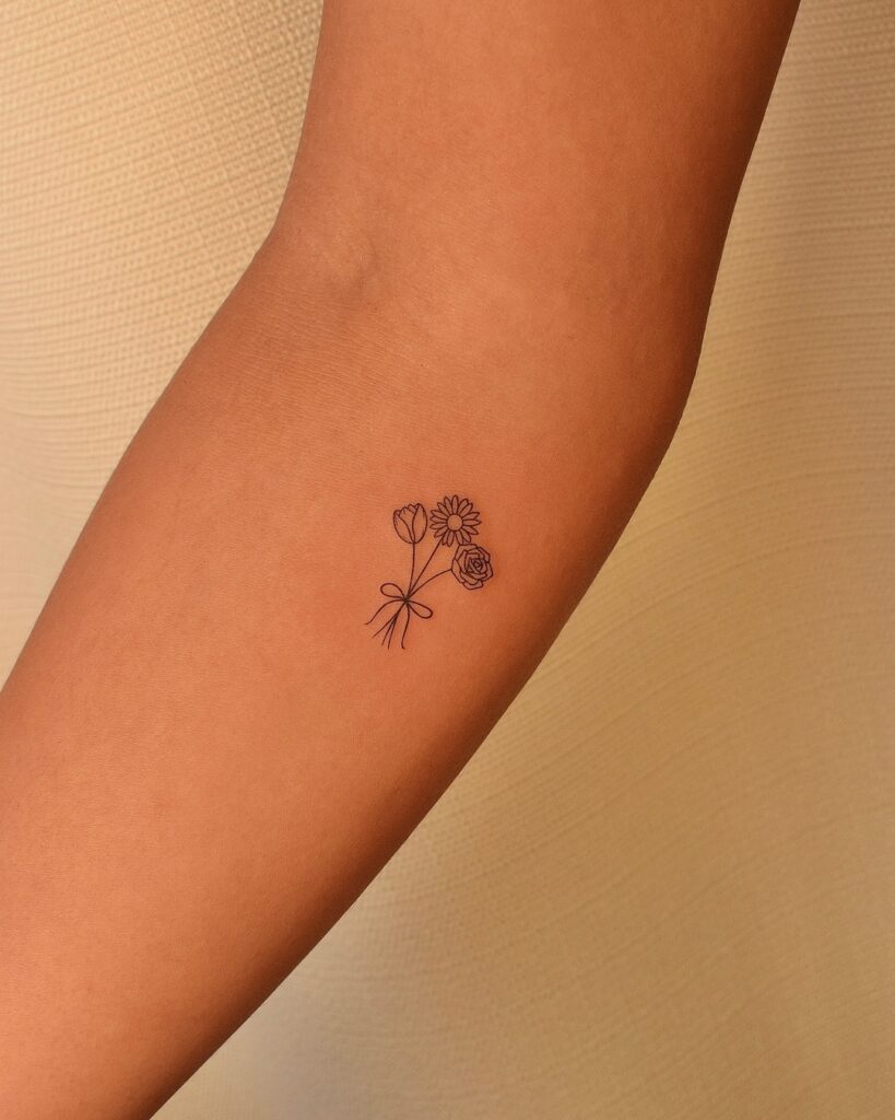 Tiny Trio Flower Bouquet Tattoo meaningful tiny tattoos tattoo