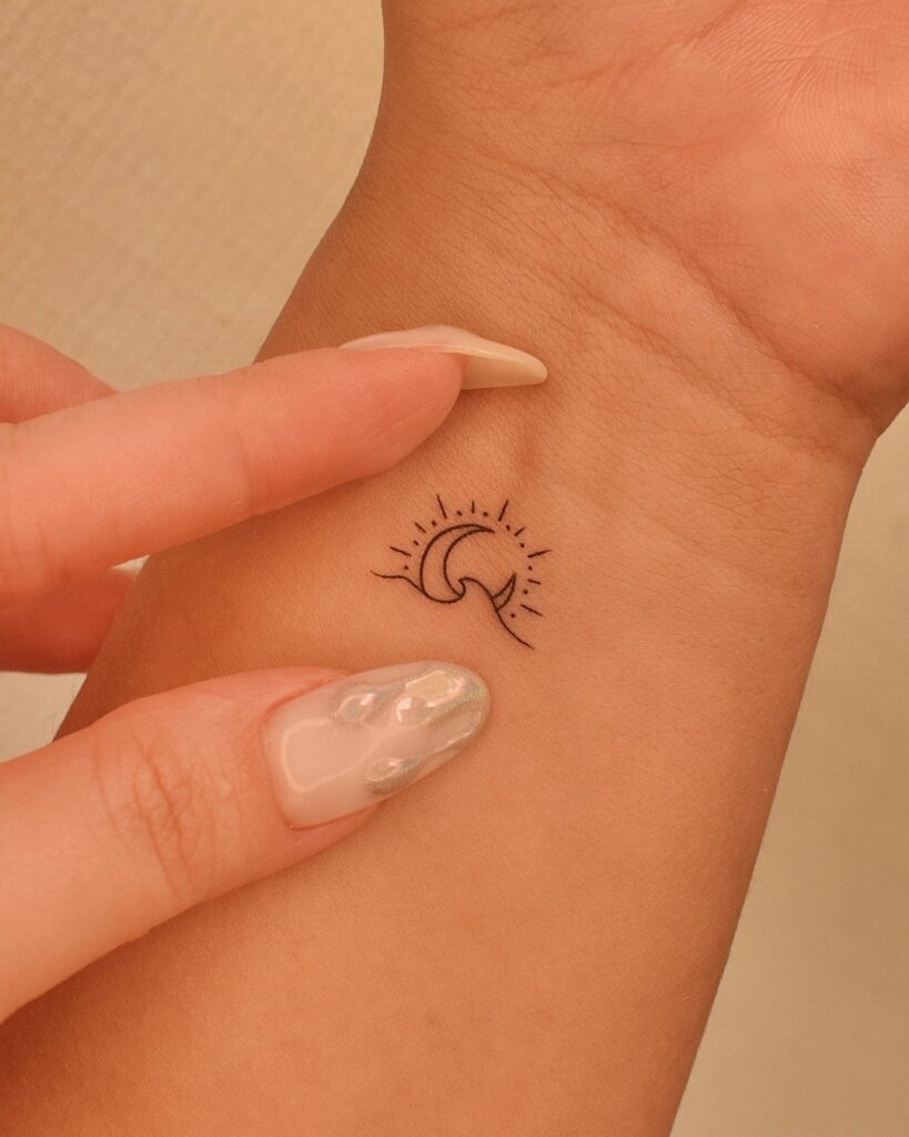 Tiny Wave and Sun Wrist Tattoo meaningful tiny tattoos tattoo