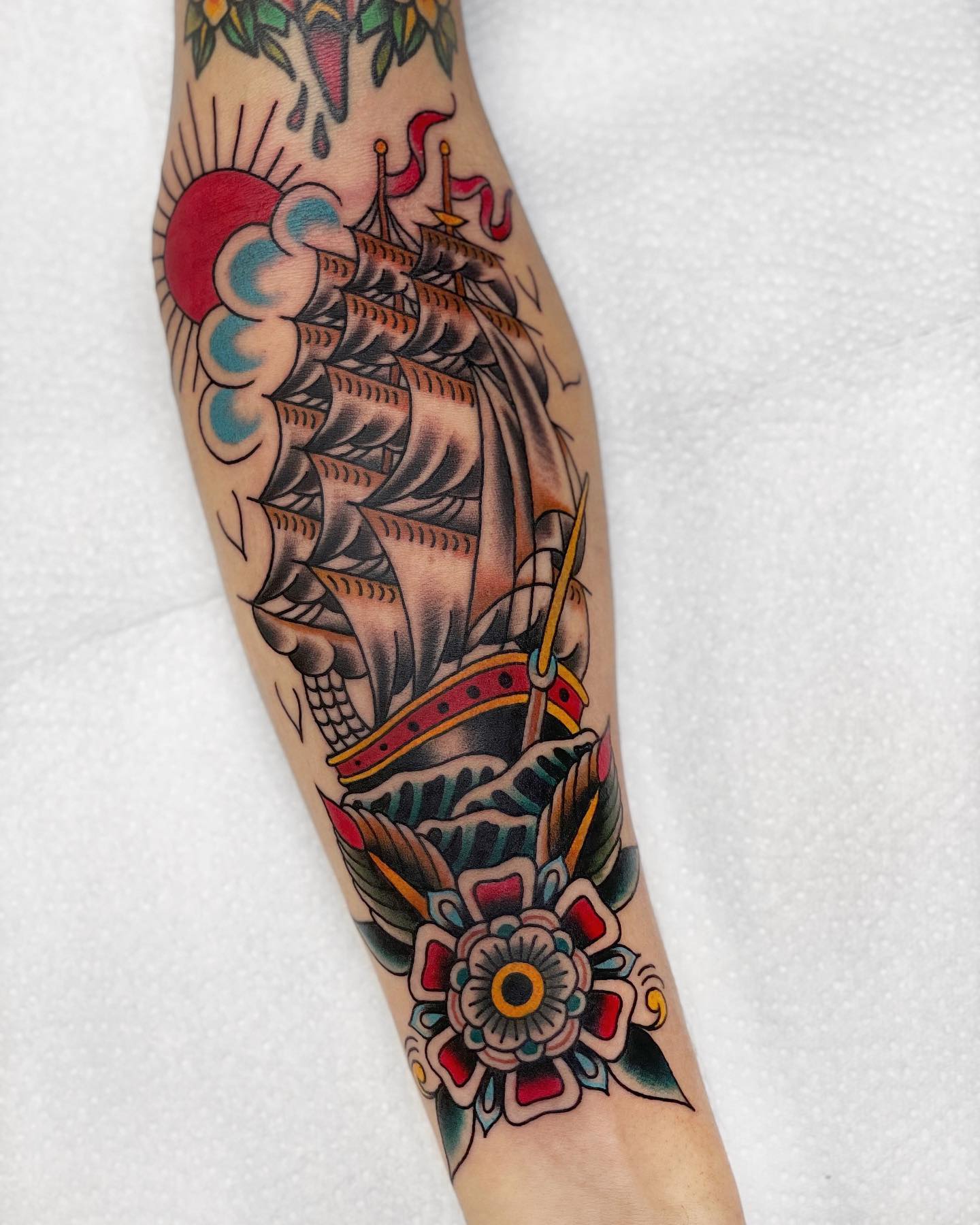 Traditional Ship With Red Sun And Flower Tattoo