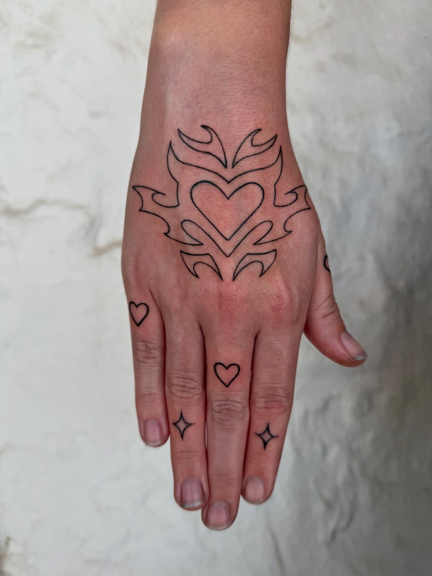 Small Rose Hand Tattoo