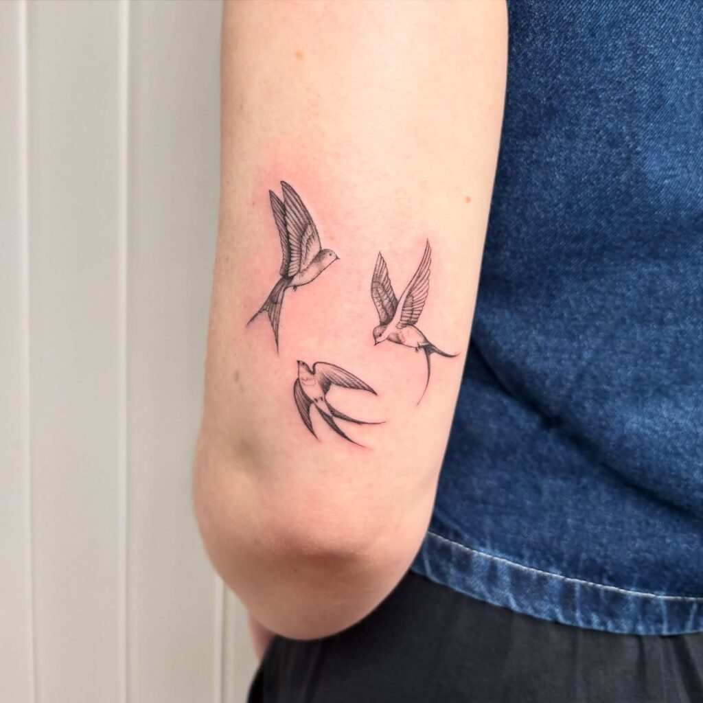 Trio of Flying Swallows Arm Tattoo bird tattoo ideas for women with meaning tattoo