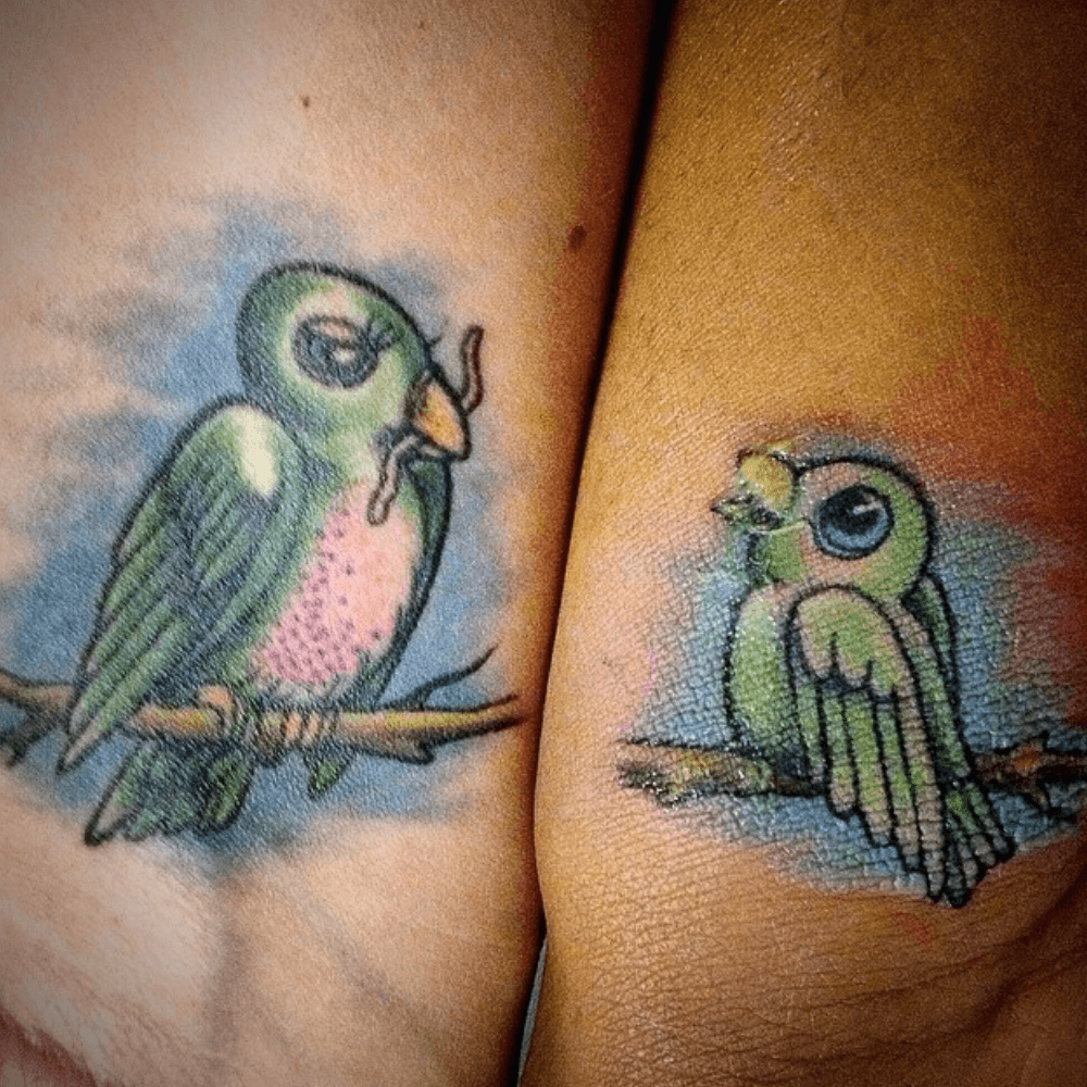 Two Birds Perched on Trees mom and son tattoo ideas tattoo