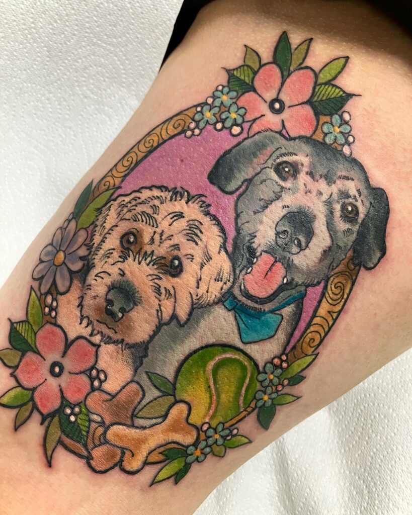 Two Dog Portraits with Floral Frame Tattoo dog memorial tattoos tattoo