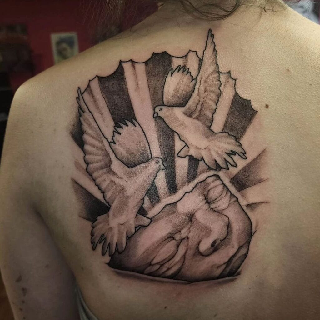 Two Doves Soaring above a Child&rsquo;s Face memorial tattoos tattoo
