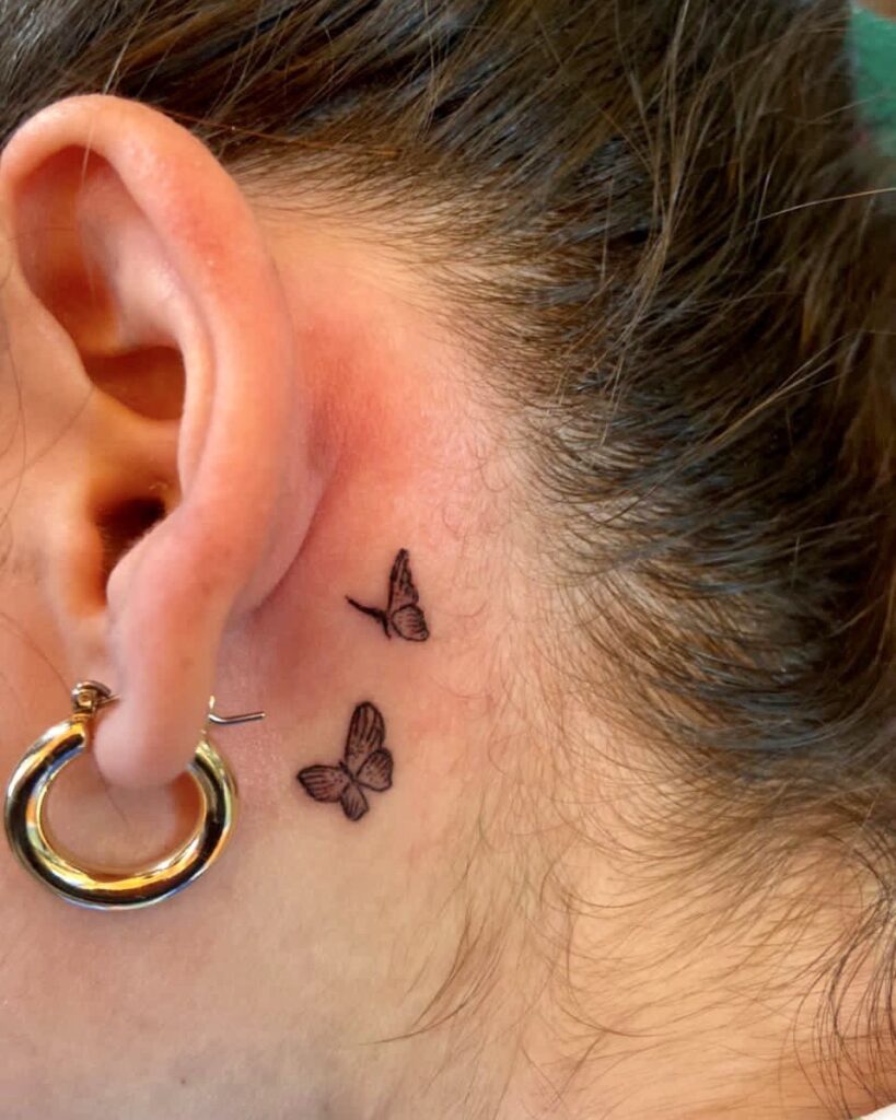 Delicate Blue Wildflower Behind Ear Tattoo
