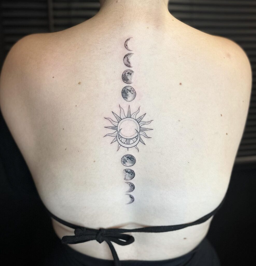 Sun and moon phases back tattoo