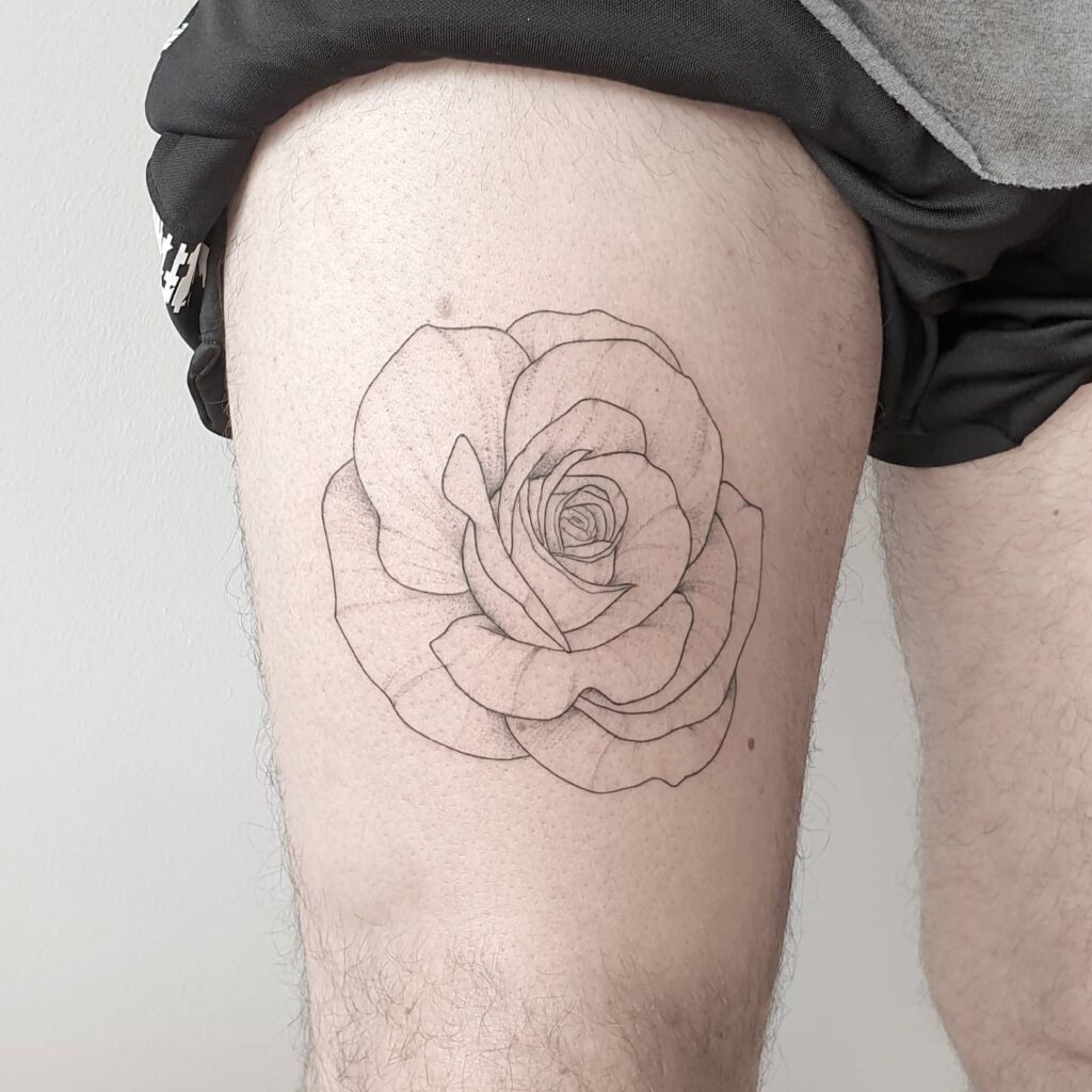 Small fine line rose tattoo on the upper thigh