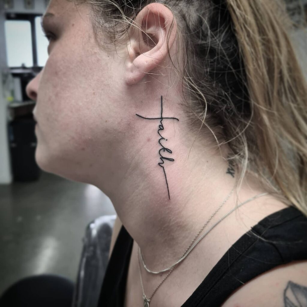 Vertical faith script behind the ear tattoo