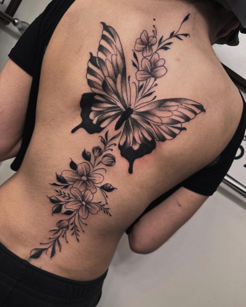 Vertical Fine Line Botanical Along the Spine tattoo