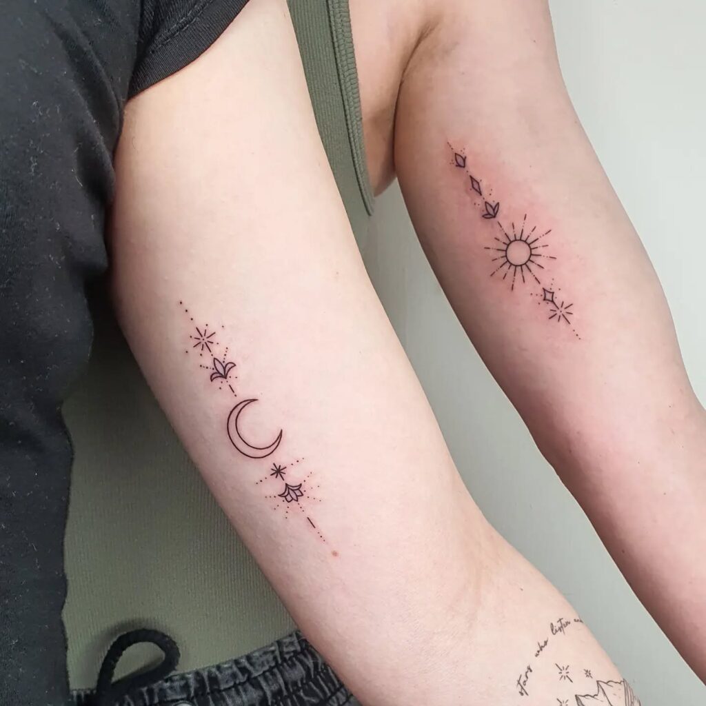 Elegant vertical sun and moon tattoos along the spine