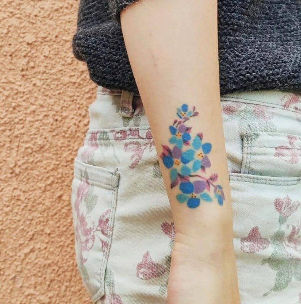 Vibrant Blue and Purple Blossom Tattoo flower wrist tattoo ideas tattoo