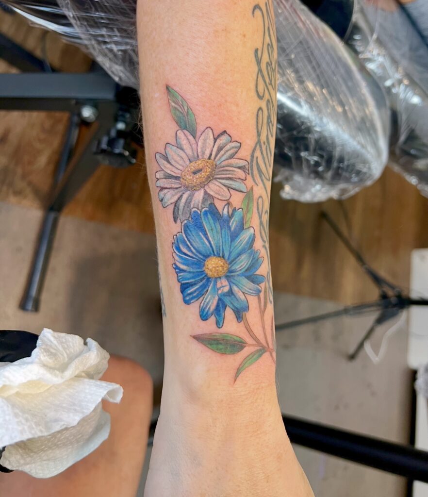 Vibrant Daisy Duo Wrist Tattoo flower wrist tattoo ideas tattoo