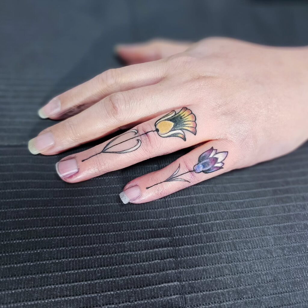 Playful Ladybug Finger Tattoo
