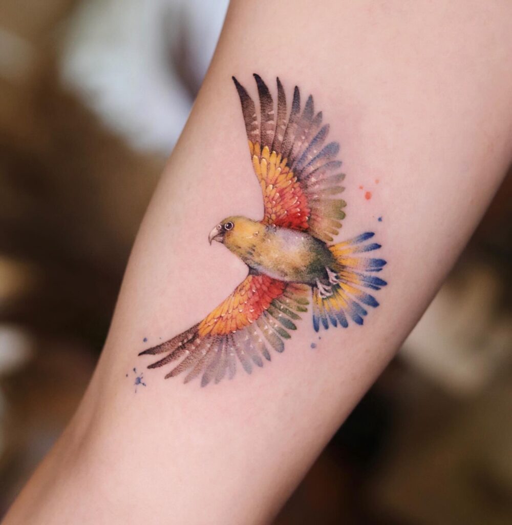 Vibrant Parrot in Flight Tattoo bird tattoo ideas for women with meaning tattoo