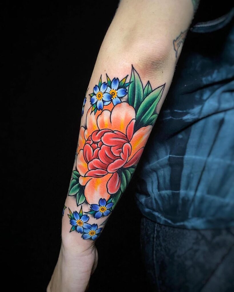 Vibrant Peony and Blue Flower Forearm Tattoo japanese peony tattoos tattoo