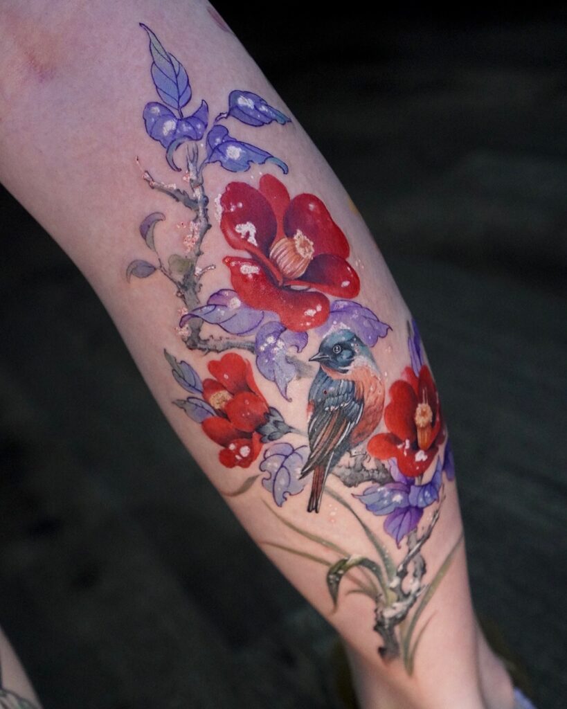 Vibrant Songbird Among Blossoms Tattoo bird tattoo ideas for women with meaning tattoo