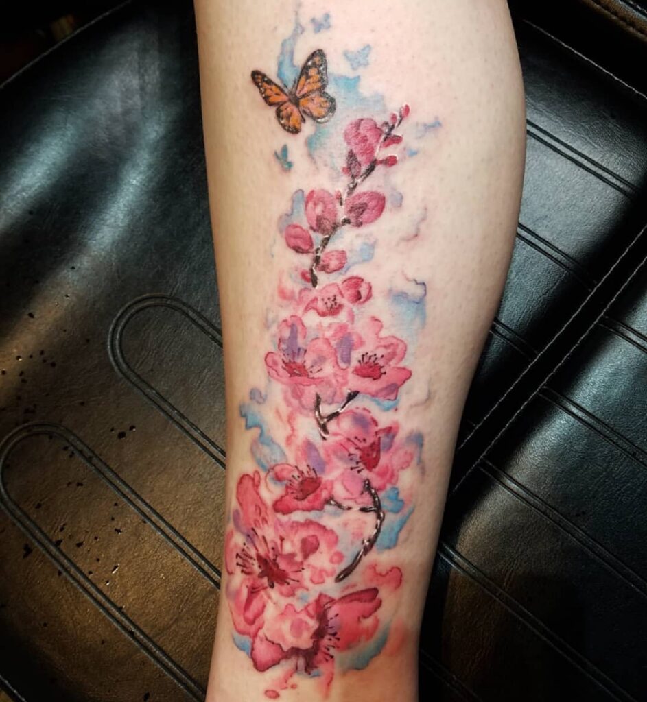 Watercolor Cherry Blossoms and Butterfly Tattoo cherry blossom tattoo ideas tattoo