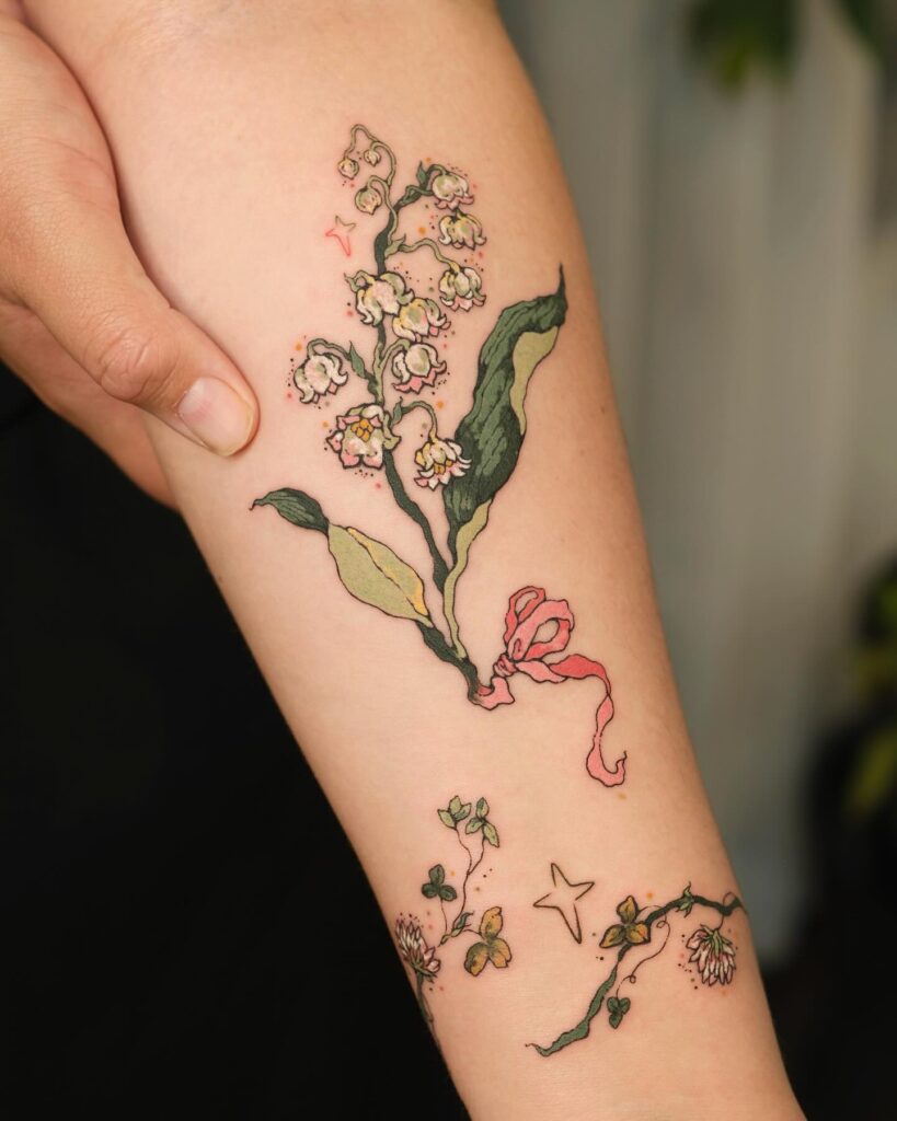 Whimsical Lily of the Valley Tattoo with Ribbon Detail may birth flower tattoos tattoo