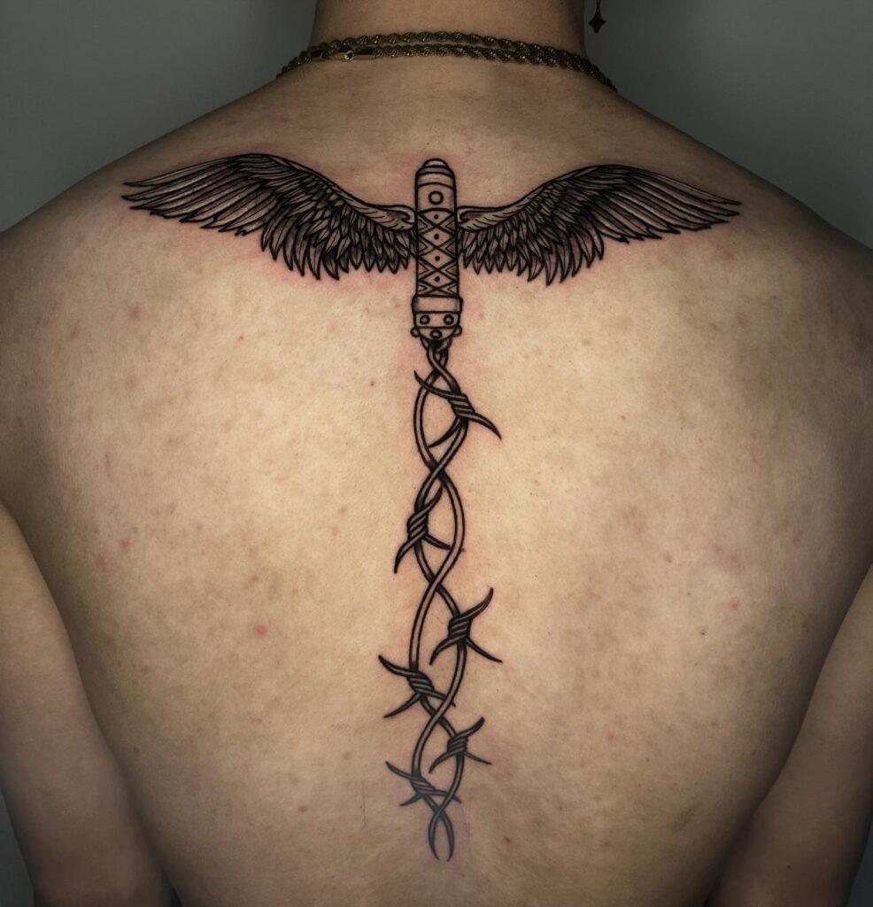 Winged Dagger and Barbed Whip Spine Tattoo angel wings tattoo ideas on back tattoo
