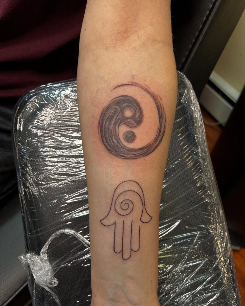 Protective Eye And Nature-Inspired Arm Tattoo