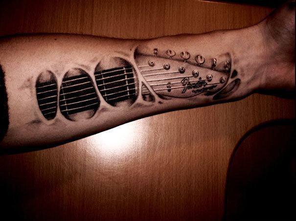 3D inserted guitar tattoo on a man’s hand Tattoo on skin