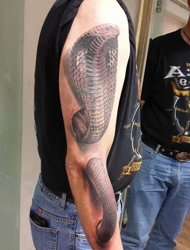 A 3D cobra tattoo on a human hand Tattoo on skin